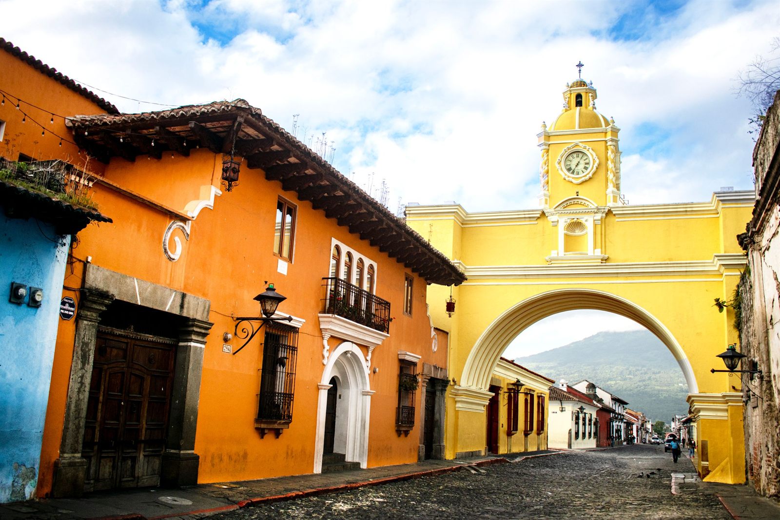 Yellow Santa Catalina Arch over a cobbled street in Antigua, Guatemala